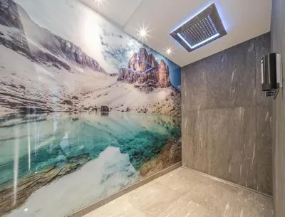 a bathroom with a sink and a mirror at Nature Hotel Delta in Colfosco