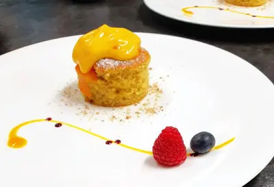 a white plate with food on a table at Nature Hotel Delta in Colfosco