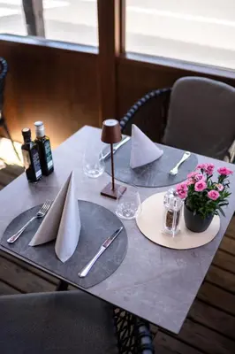 a table with two plates and napkins on it at Hotel Laurin in Canazei