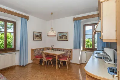 a kitchen and dining room with a table and chairs at Appartements Eppanerhof in Appiano sulla Strada del Vino