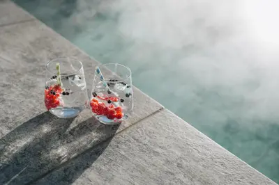 two glasses with strawberries in them sitting on a table at Hotel Wochtla Buam Aktivhotel am Kronplatz mit Sauna in Brunico