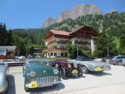 a group of cars parked in front of a building at Hotel Borest in Colfosco