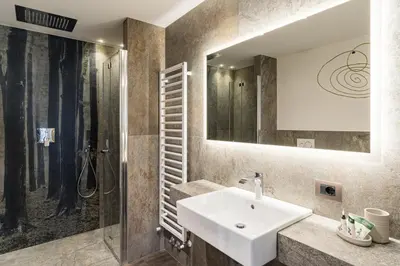 a bathroom with a sink and a shower at Albergo Centrale in San Martino di Castrozza