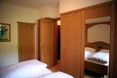 a bedroom with two beds and two closets at Residence Riposo in Colfosco