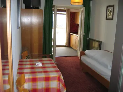 a bedroom with a bed and a table in a room at Residence Riposo in Colfosco