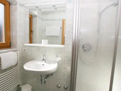 a bathroom with a sink and a shower at Ciasa Parom in San Cassiano