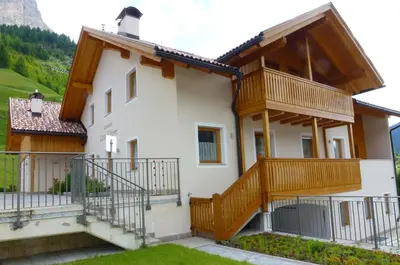 a house with wooden balconies on the side of it at Residence Ciasa Dl Mone in Colfosco