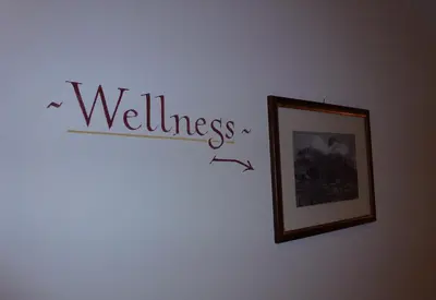 a wall with a sign that says wellness on it at Residence Ciasa Dl Mone in Colfosco