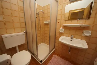 a bedroom with a bed and a table and a window at Runcac in Badia