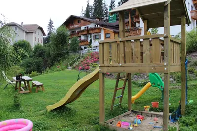 a playground with a slide in a yard at Runcac in Badia