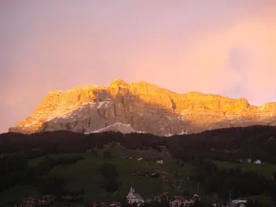 a mountain with the sun shining on it at Runcac in Badia
