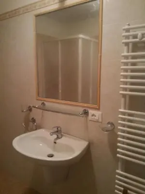a bathroom with a sink and a mirror at Casa Lausen in Canale San Bovo