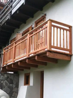 a wooden deck on the side of a building at Casa Lausen in Canale San Bovo
