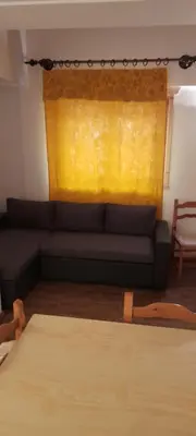 a living room with a couch and a yellow window at Agriturismo Fattoria Meneguto Societa Agricola Semplice in Cortina dʼAmpezzo