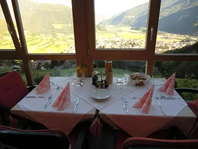 a table with a white table cloth and watermelons on it at Alpenblick Bed & Breakfast in Vipiteno