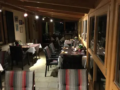 a dining room with tables and chairs in a restaurant at Alpenblick Bed & Breakfast in Vipiteno