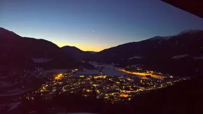 a view of a city at night with mountains at Alpenblick Bed & Breakfast in Vipiteno