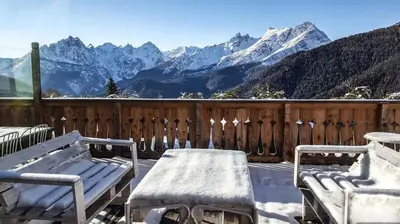 a view of mountains and houses in a village at HG Hotel La Caminatha in Val di Zoldo