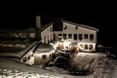 a bedroom with a bed with a view of a mountain at HG Hotel La Caminatha in Val di Zoldo