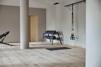 an empty room with two chairs and a pole at Forestis Dolomites in Bressanone