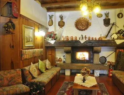 a large swimming pool with a ceiling and chairs at Hotel Tyrolia in Malga Ciapela