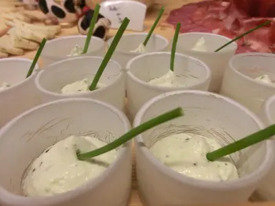 a group of white dishes with green grass sticking out of them at Hotel Tirolerhof in Rodengo