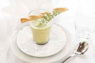 a drink on a white plate on a table at Hotel Tirolerhof in Rodengo