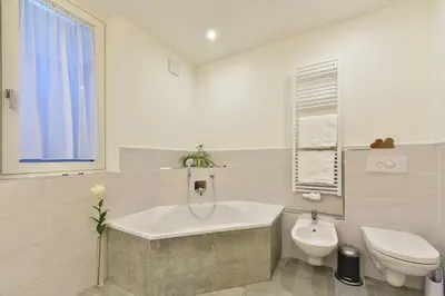 a bathroom with a tub and a toilet and a sink at Anger living in Laion