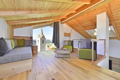 a living room with a couch and a church at Anger living in Laion