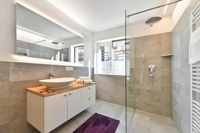 a bathroom with a sink and a glass shower at Anger living in Laion