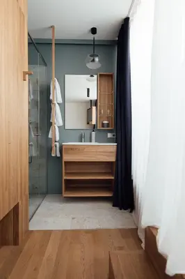 a bathroom with a glass shower and a sink at Haus am Turm in Vipiteno