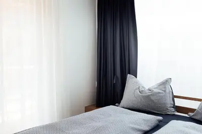 a bedroom with a bed with a pillow and a window at Haus am Turm in Vipiteno