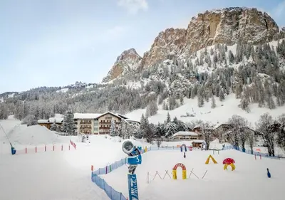 a ski resort in the snow with a mountain at Pensione Sellablick in Colfosco