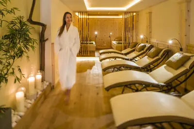 a woman standing in a room with rows of chairs at Alpin Hotel Sonnblick in Perca