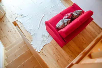 a red pillow and a white furry pillow on a table at Beauty & Vital Hotel Maria in Carano