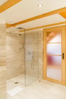 a bathroom with a white tub and a window at Beauty & Vital Hotel Maria in Carano