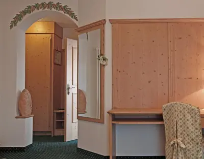 a room with a dressing table and a mirror at Beauty & Vital Hotel Maria in Carano