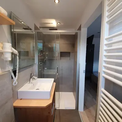 a bathroom with a sink and a shower at Haus Herta B&B in Nova Levante