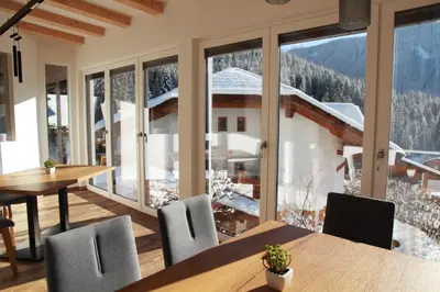 a dining room with a view of a snowy mountain at Haus Herta B&B in Nova Levante