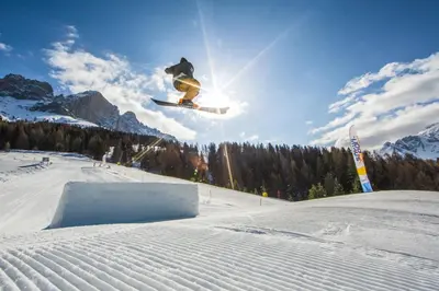 a man flying through the air while riding a snowboard at Haus Herta B&B in Nova Levante