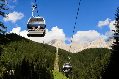 two cars on a ski lift in the mountains at Haus Herta B&B in Nova Levante