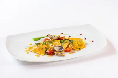 a plate of food on a white plate at Hotel Rosskopf in Vipiteno