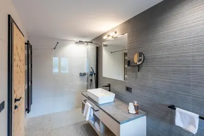 a bathroom with a sink and a mirror at Hotel Rosskopf in Vipiteno