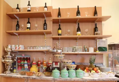 a bar with bottles of wine on shelves at Das Filipinum in Merano