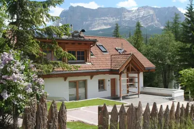 a house in the mountains with a fence at Casa Zilli in La Villa
