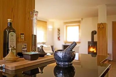a kitchen with a counter with a bottle of wine at Casa Zilli in La Villa