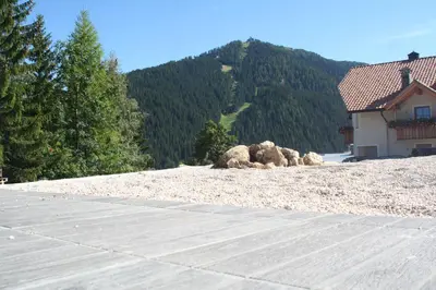 a pile of rocks on a hill with a house at Casa Zilli in La Villa