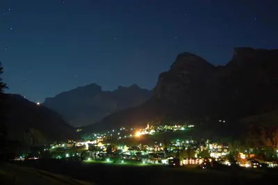 a view of a town at night with mountains at Casa Zilli in La Villa