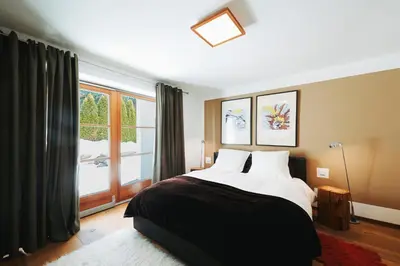 a bedroom with a bed and a large window at Casa Zilli in La Villa
