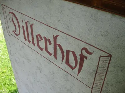 a sign that reads whisper dog written on a rock at Dillerhof in Laion